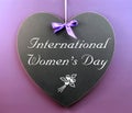 International Women's Day message written on heart shape blackboard