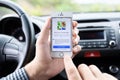 IPhone 5s with Google Maps in the hands of driver