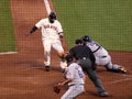 Juan Uribe gets tagged out at the plate by catcher