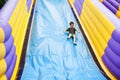 Large slide playground happy kid on a inflatable Stock Photo