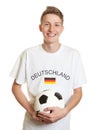 Laughing german soccer fan with blond hair and ball