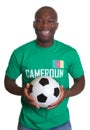 Laughing soccer fan from Cameroon with ball