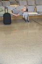 Male Traveler Lying On Chairs In Lobby