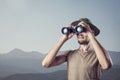 Man with binocular in the mountains