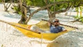 Man Relaxing In A Hammock On T...