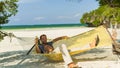 Man Relaxing In A Hammock On T...