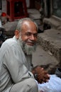 Man smiles for camera lahore pakistan september a bearded as he looks towards the inside the historical walled city of Stock Photography