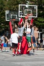 Men Jump While Fighting For Ball In Street Basketball Tournament