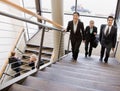 Multi-ethnic workers ascending office stairs