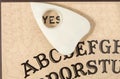 Ouija board with the planchette pointing to YES