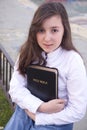 Portrait of beautiful girl holding bible