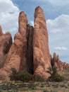 Rock fins in desert red sandstone fin shaped cliffs line up the with a partly cloudy blue sky arches national park utah Royalty Free Stock Photo