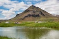 Scenic landscape with village and volcano in Iceland.