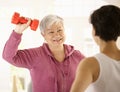 Senior woman doing dumbbell exercise Stock Image