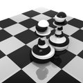 Sliced black and white pawns on chessboard