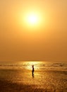 A small girl silhouetted against sun set Royalty Free Stock Photos