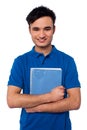 Smiling student embracing his note book cheerful college holding notebook against white Royalty Free Stock Images