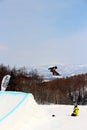 Snowboarder going off a big jump in hanazono park