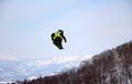 Snowboarder  going off a big jump in hanazono park