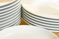 Stacks of white dinner plates