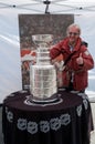 The Stanley Cup with a supporter