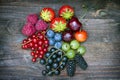 Summer wild berry fruits on vintage board still life