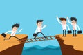 Teamwork businessman steps over ladder to another cliff Royalty Free Stock Images