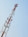 Telecommunication antenna white and red high in daytime Royalty Free Stock Photography