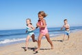 Three Children Running Along B...
