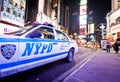 Times Square at evening with NYPD car