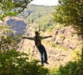 Tourist trying valley crossing on ropeway Royalty Free Stock Photo