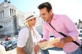 Tourists looking at map before visiting monument of Victor Emmanuel II