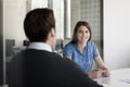 Two Business People Sitting At...