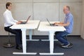 Two men working in correct sitting posture on pneumatic leaning seats