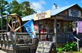 Village general store southport nc in with some old antique coca cola signs hanging out front and a water wheel on the side Royalty Free Stock Photo