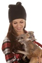 Woman in beanie and plaid shirt baby kangaroo look down