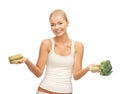 Woman with broccoli and hamburger picture of sporty Royalty Free Stock Image