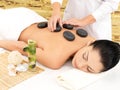 Woman Having Stone Massage Of ...