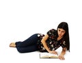 Young attractive girl lying and reading book Stock Images