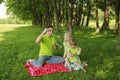 Young Family Blowing Bubbles O...
