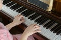The young girl learns to play a piano