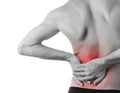 Young man holding his back in pain, isolated