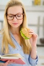 Young Woman Eating Sandwich An...