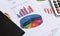 Business charts and graphs with book and calculator