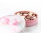 Chocolates in pink box on white background