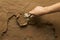 Close-up of hand using trowel to finish wet concrete floor