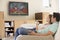 Couple in living room watching television