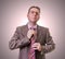 Thoughtful businessman putting his tie on white background