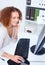 Top view of a friendly office woman using computer