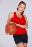 Attractive woman with a basketball Royalty Free Stock Image